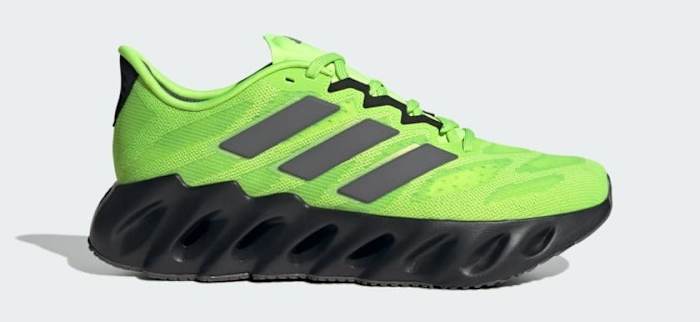 Side view of a green and black adidas shoe.